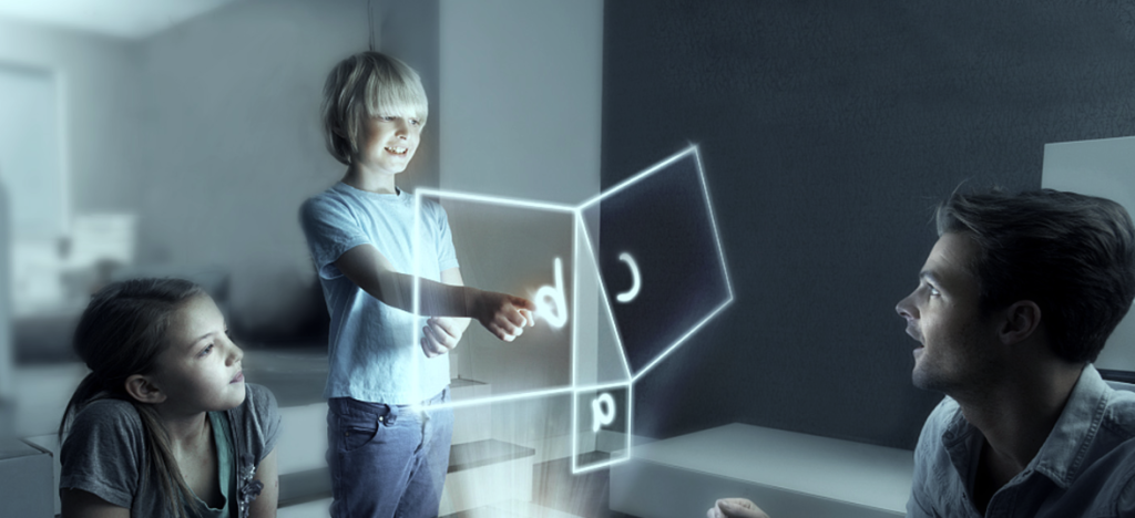 A boy and a girl are sitting on a couch in a living room. The boy is holding a glowing 3D cube in his hands.