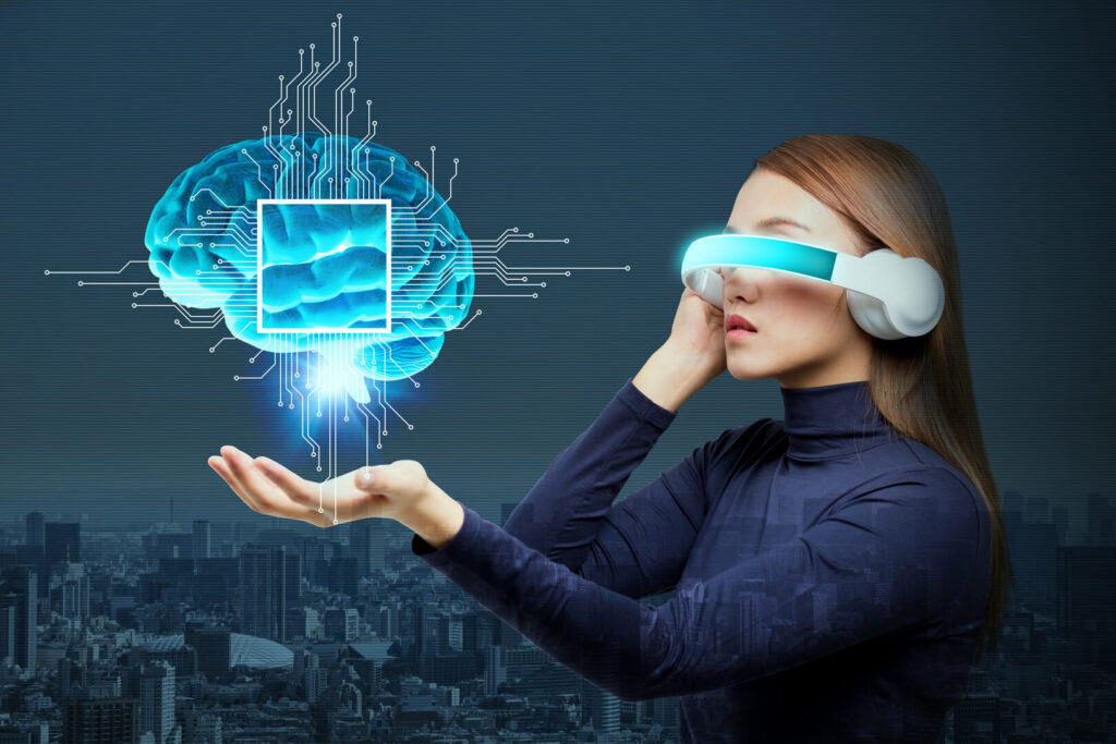 The picture shows a woman wearing a virtual reality headset. She is holding a 3D model of a brain in her hand.
