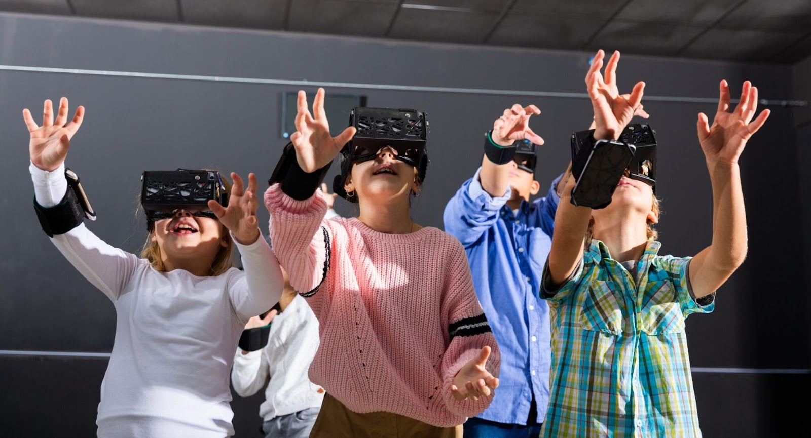 A group of Generation Alpha children experiencing virtual reality, reaching out with their hands, fully immersed and fascinated by the technology.