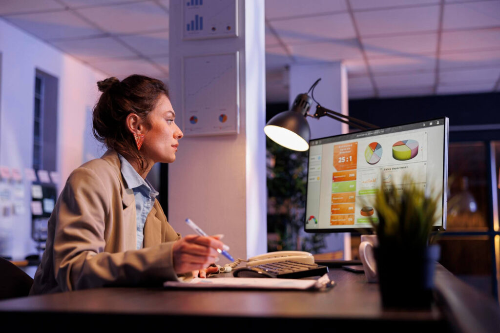 A doctor working at a desk with a computer.